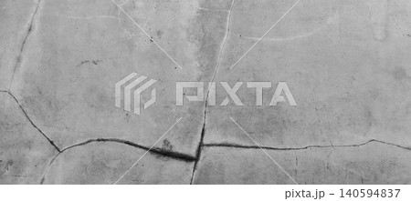 Close up of a grey concrete wall texture showing natural cracks and weathered surfaces. Close up of a grey concrete wall texture showing natural cracks and weathered surfaces. 140594837