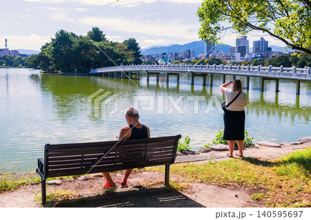 tourist woman view bridge to hexagonal pavilion of Ohori park, Fukuoka 140595697