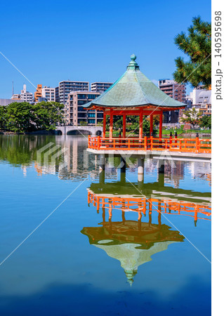 Iconic hexagonal red pavilion of Ohori lake park with Fukuoka city Iconic hexagonal red pavilion of Ohori lake park with Fukuoka city 140595698