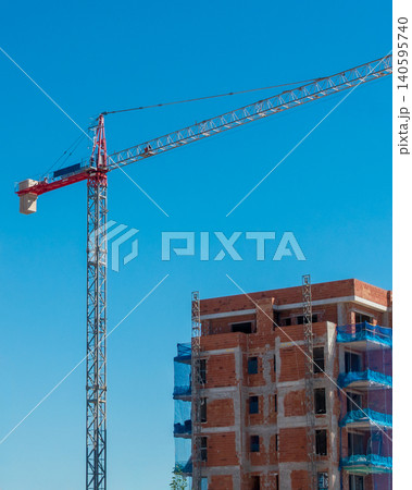 Urban Housing Construction Site with Crane and Building Structure 140595740