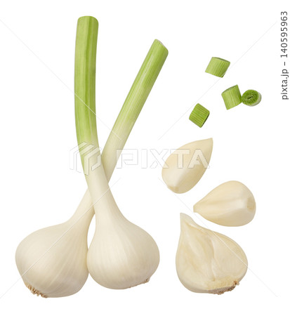 Set of young garlic and pieces close-up on a white background. Isolated Set of young garlic and pieces close-up on a white background. Isolated 140595963