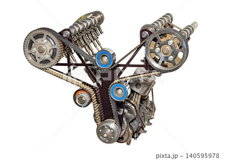 Mechanical parts of a complex engine with gears and belts in a workshop setting during daytime Mechanical parts of a complex engine with gears and belts in a workshop setting during daytime 140595978