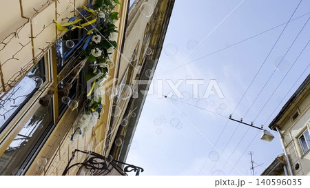 Soap bubbles float through sunlit city street with beautiful architecture in background. The light reflects on their transparent surfaces creating playful and airy summer mood in an urban environment 140596035