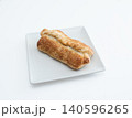 Freshly baked puff pastry roll on a white plate. 140596265
