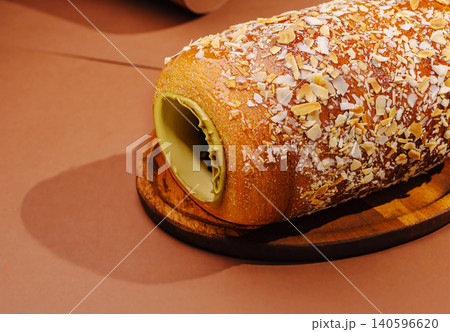 Freshly baked chimney cake with pistachio cream and almond flakes Freshly baked chimney cake with pistachio cream and almond flakes 140596620