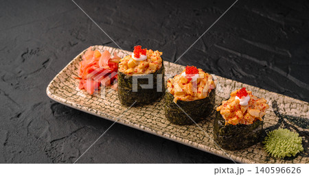 Gunkan sushi serving with seafood topping and tobiko Gunkan sushi serving with seafood topping and tobiko 140596626