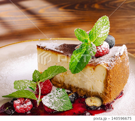 Cheesecake slice with fresh berries and mint Cheesecake slice with fresh berries and mint 140596675