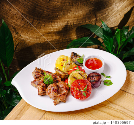 Grilled meat and roasted vegetables on plate 140596697