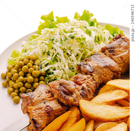 Grilled meat skewer with potato wedges and fresh salad Grilled meat skewer with potato wedges and fresh salad 140596715