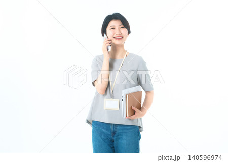 白背景で電話をしながら大きく笑う若い女性 白背景で電話をしながら大きく笑う若い女性 140596974