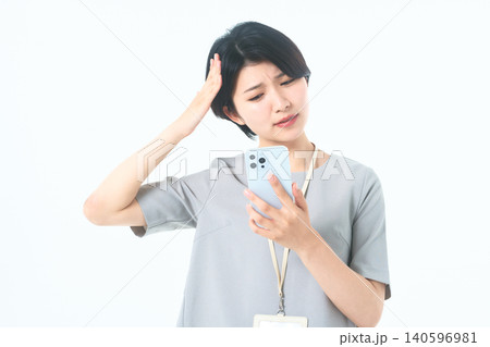 白背景でスマホの通知に驚き困惑する若い女性 白背景でスマホの通知に驚き困惑する若い女性 140596981