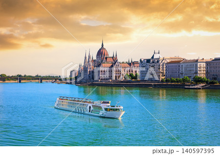 Hungarian Parliament Building at sunset with cruise ship on the Danube river, Budapest, Hungary Hungarian Parliament Building at sunset with cruise ship on the Danube river, Budapest, Hungary 140597395
