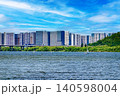 Modern residential apartment buildings along a wide Han river under a bright blue sky 140598004