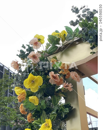 Close Up Of Artificial Floral Installation On Golden Architectural Structure 140598030