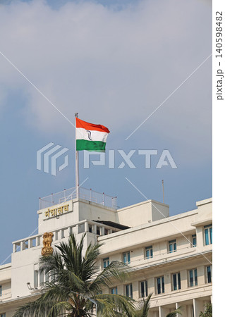 Mumbai Maharashtra India Jan 18 2026 Indian tricolor flying above Mantralaya rooftop with Maharashtra Secretariat signage against a bright blue sky Mumbai Maharashtra India Jan 18 2026 Indian tricolor flying above Mantralaya rooftop with Maharashtra Secretariat signage against a bright blue sky 140598482