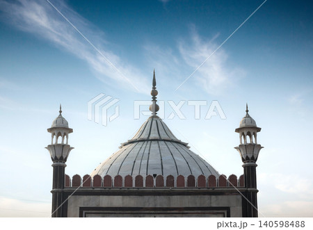 Delhi, India, November 28, 2025. Close-Up View of Jama Masjids Central Dome and Minarets Against a Soft Evening Sky Delhi, India, November 28, 2025. Close-Up View of Jama Masjids Central Dome and Minarets Against a Soft Evening Sky 140598488