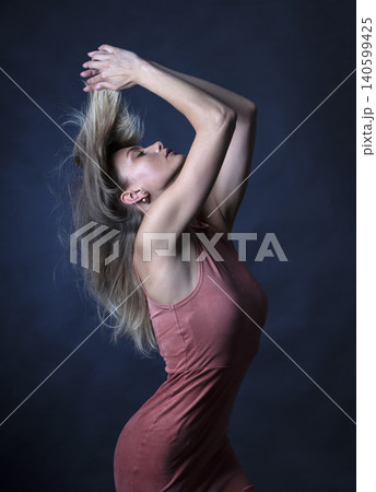 portrait of a young attractive woman on a dark background 140599425