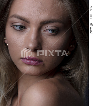 portrait of a young attractive woman on a dark background 140599479