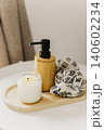 Still life of luxury spa essentials. A bottle with a massage oil and candle on a table. 140602234
