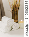 Minimalist still life of luxury spa essentials. White cotton towels with candle on a table. 140602236