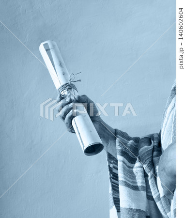 Male hand holding an old scroll 140602604