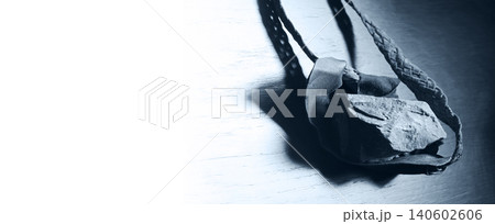 Sling with stone on wooden background Sling with stone on wooden background 140602606