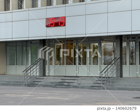 Modern office entrance with access doors, stairways and digital clock display on building facade in urban business environment. Corporate security, workplace, office operations, architecture Modern office entrance with access doors, stairways and digital clock display on building facade in urban business environment. Corporate security, workplace, office operations, architecture 140602679