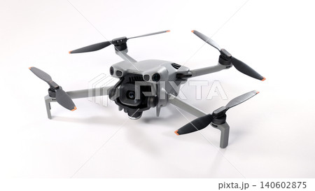 Drone camera. Modern camera drone with remote controller on white background. UAV or Unmanned Aerial Vehical technology for aerial photography videography mapping inspection and recreational flying. Drone camera. Modern camera drone with remote controller on white background. UAV or Unmanned Aerial Vehical technology for aerial photography videography mapping inspection and recreational flying. 140602875