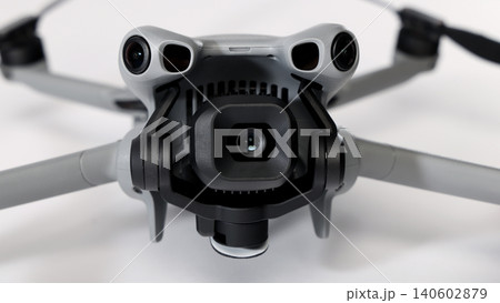 Drone camera. Modern camera drone with remote controller on white background. UAV or Unmanned Aerial Vehical technology for aerial photography videography mapping inspection and recreational flying. Drone camera. Modern camera drone with remote controller on white background. UAV or Unmanned Aerial Vehical technology for aerial photography videography mapping inspection and recreational flying. 140602879
