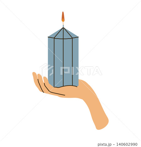 Human hand holding a lit blue pillar candle cozy concept 140602990