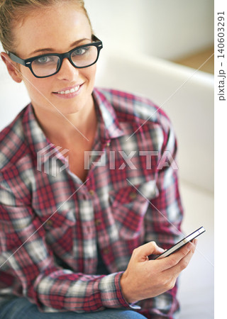 Woman, portrait and online with phone in home for communication, social media or mobile chat with smile. Person, face and happy with smartphone for text message, internet scroll or email with glasses 140603291
