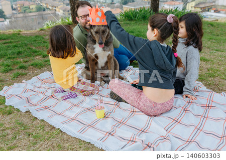 Children Celebrating a Dog's Birthday Picnic in the Park Children Celebrating a Dog's Birthday Picnic in the Park 140603303