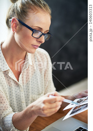 Work, home office and woman look at paper to review brand or graphic design, creative and startup business for freelancer. Female person, check and laptop for research for company logo, image and job Work, home office and woman look at paper to review brand or graphic design, creative and startup business for freelancer. Female person, check and laptop for research for company logo, image and job 140603313