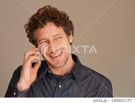 Mature man, phone call and smile in studio for thinking, listening and chat for news with connection background. Person, smartphone and happy with ideas for conversation, contact or mobile networking 140603377