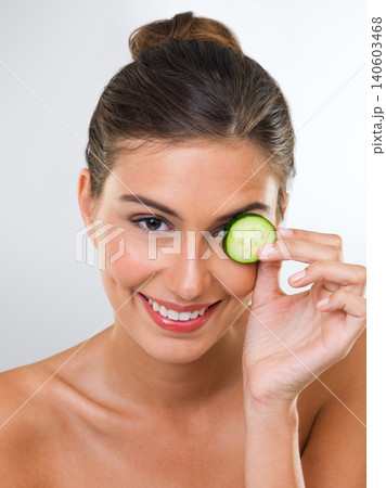 Woman, portrait and cucumber for health in studio with wellness detox, healthy eating and nutrition diet. Model, person and fruit for organic cosmetics, natural beauty or skincare on white background Woman, portrait and cucumber for health in studio with wellness detox, healthy eating and nutrition diet. Model, person and fruit for organic cosmetics, natural beauty or skincare on white background 140603468
