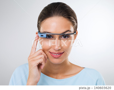 Portrait, happy woman and futuristic glasses for augmented reality, vision or metaverse online. Face, cyber eyewear and smart technology for person with smile in studio isolated on a white background Portrait, happy woman and futuristic glasses for augmented reality, vision or metaverse online. Face, cyber eyewear and smart technology for person with smile in studio isolated on a white background 140603620