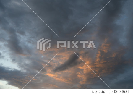 Dramatic sunset or sunrise with contrasting clouds heavy dark thunderclouds in gray and blue shades 140603681