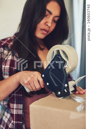 Ecommerce, business or woman with box, tape or sale product for shipping, distribution or order package. Logistics, online shopping or lady with cardboard container for retail stock, cargo or freight Ecommerce, business or woman with box, tape or sale product for shipping, distribution or order package. Logistics, online shopping or lady with cardboard container for retail stock, cargo or freight 140603748