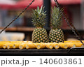 Two pineapples on outdoor grill corn cobs eye level view Two pineapples on outdoor grill corn cobs eye level view 140603861
