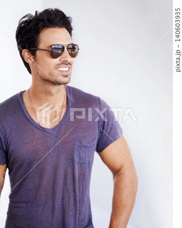 Happy, man and fashion with sunglasses on wall outdoor with confidence, cool style and pride. Summer, holiday and person smile in casual outfit for vacation, break and relax on white background Happy, man and fashion with sunglasses on wall outdoor with confidence, cool style and pride. Summer, holiday and person smile in casual outfit for vacation, break and relax on white background 140603935