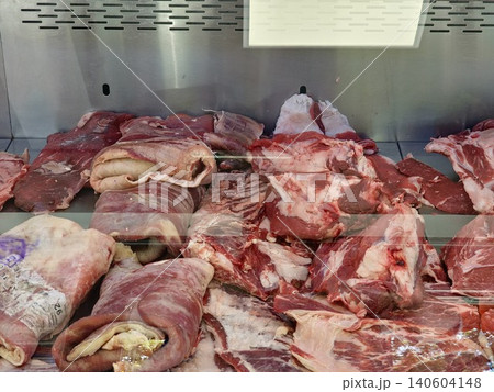 Assorted raw meat products displayed in butcher shop refrigerator Assorted raw meat products displayed in butcher shop refrigerator 140604148