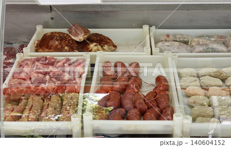 Prepared meat products and sausages arranged in butcher shop display case Prepared meat products and sausages arranged in butcher shop display case 140604152