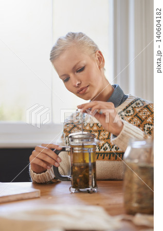 Woman, happy and herbal tea to relax in home and warm beverage of herbs mixture for health. Calm, designer and creative idea with dried leaves in plunger and wellness for detox drink in mason jar Woman, happy and herbal tea to relax in home and warm beverage of herbs mixture for health. Calm, designer and creative idea with dried leaves in plunger and wellness for detox drink in mason jar 140604182