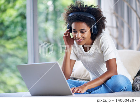Black woman, headphones and laptop at home for online teaching, e learning and education in living room. Female person, scholar and university student in house for remote class, studying and tuition Black woman, headphones and laptop at home for online teaching, e learning and education in living room. Female person, scholar and university student in house for remote class, studying and tuition 140604207