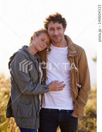 Couple, hug in nature and portrait in park, love and support with date for bonding and time together. Sunset, calm and people in forest for fresh air, loyalty and commitment with peace outdoor Couple, hug in nature and portrait in park, love and support with date for bonding and time together. Sunset, calm and people in forest for fresh air, loyalty and commitment with peace outdoor 140604315