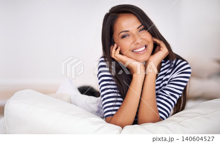 Woman, portrait and lying on sofa with relaxing, smile and comfortable in living room. Female person, happy and resting in couch or lounge for break or Saturday with casual outfit and leisure at home Woman, portrait and lying on sofa with relaxing, smile and comfortable in living room. Female person, happy and resting in couch or lounge for break or Saturday with casual outfit and leisure at home 140604527