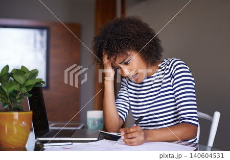 Woman, finance and thinking of problem at home, table with documents for tax and calculating debt. African female person, bills and stress of online payment report, budget and planning with worry Woman, finance and thinking of problem at home, table with documents for tax and calculating debt. African female person, bills and stress of online payment report, budget and planning with worry 140604531
