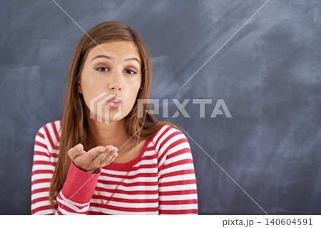 Portrait, woman and blowing a kiss with blackboard, romance and funny with fun and mockup space. Face, person and girl with love and symbol with emoji and icon with model and cheerful with happiness 140604591