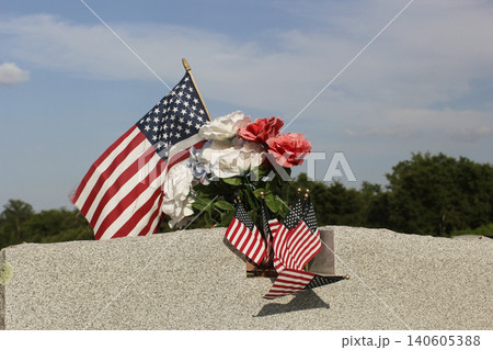 Close up of Military Veteran Headstone With American Flags 140605388