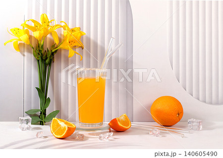 Orange juice, cocktail and ice cubes on sunny elegant background, modern still life with lilies, summer party concept, minimalist abstract background for alcoholic drinks presentation, design template Orange juice, cocktail and ice cubes on sunny elegant background, modern still life with lilies, summer party concept, minimalist abstract background for alcoholic drinks presentation, design template 140605490